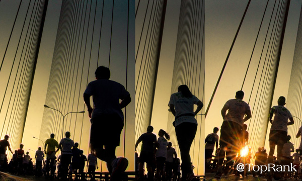 Marathon runners on bridge image.