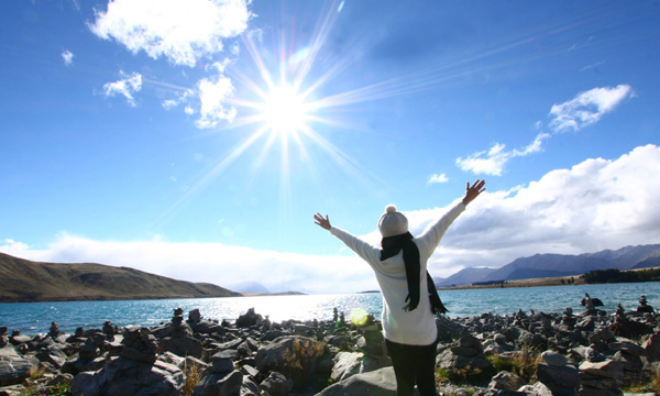 Woman with outstretched arms on a clear day image.