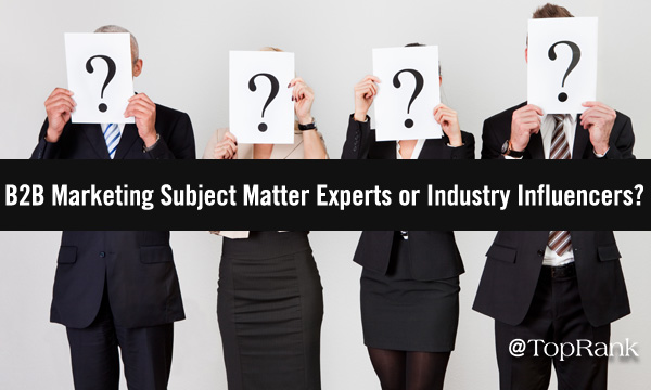 Four businesspeople holding question mark signs over their faces image.